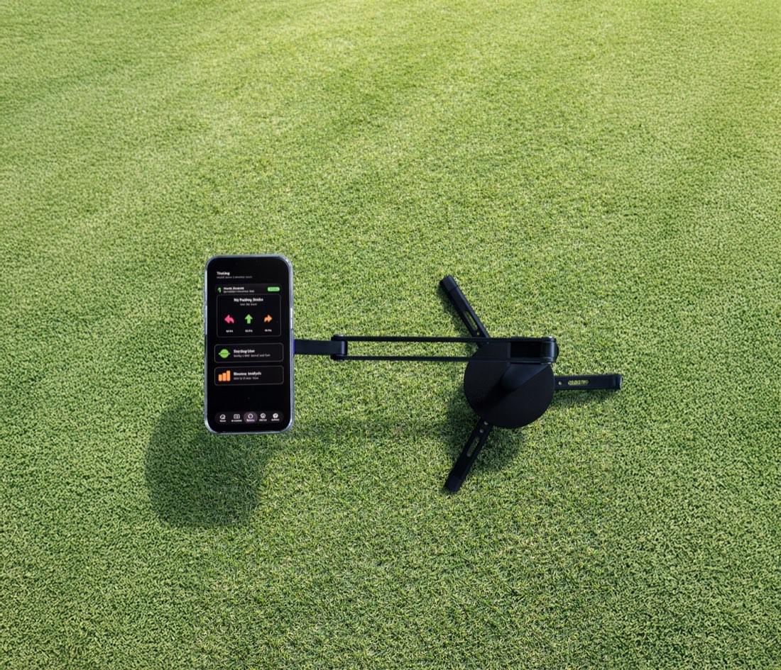 Architecture Air staked into a practice green with a phone mounted, ready to capture